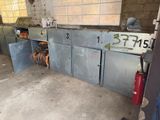 a fire extinguisher in a garage with a lot of cabinets