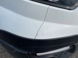 a close up of the front of a car with a denting dent