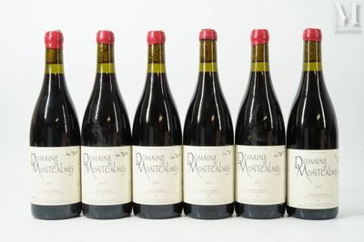 six bottles of red wine lined up in a row on a white surface