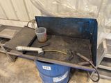 a blue barrel with some tools on it in a room