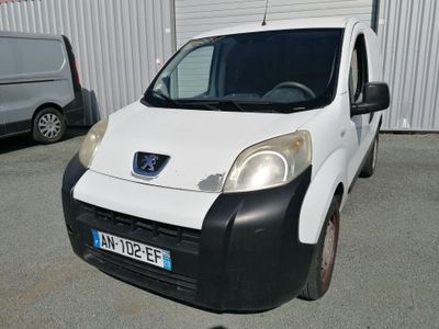 a small white van parked in a parking lot