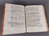 an open book on a table with a gray background