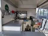 an image of a kitchen with a stove, sink, and refrigerator