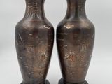 pair of antique bronze vases with asian writing on them