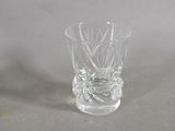 a clear glass with a design on it on a table
