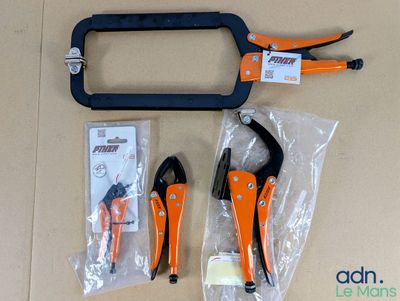 two pliers and a pair of pliers sitting on a table