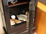a small black cabinet with a television on top of it