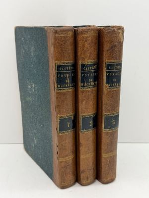 three old books sitting on top of each other on a table