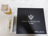 an open box of perfume sitting on top of a table next to a box of perfume