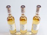 three bottles of wine sitting next to each other on a table