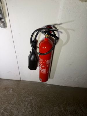 a fire extinguisor attached to a wall next to a door