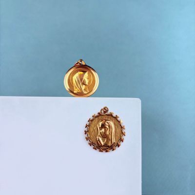 a gold medal with a picture of a woman on it