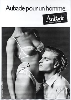 an advertisement for an advertiser of a man and a woman in underwear
