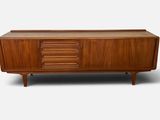 the sideboard is made of wood and has four drawers
