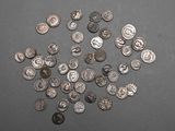 a pile of silver coins on a table