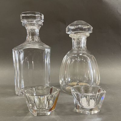 two glass bottles sitting next to each other on a table