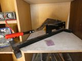 a clamp and a hammer on a shelf in a room