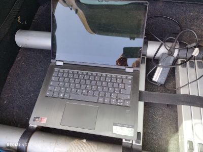 a laptop computer that is sitting on the floor of a car