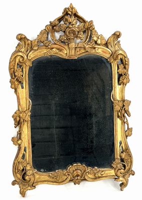 a mirror with a gold frame on a white background
