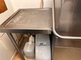 a metal table that has two containers on it