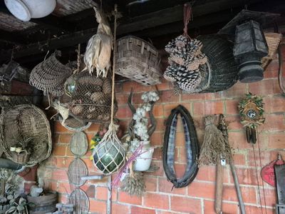 many baskets hanging on the wall of a brick building
