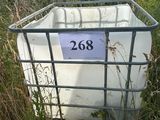 a large white container sitting in the middle of a field