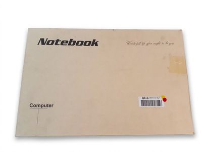 a close up of a notebook on a white surface with a red dot