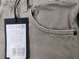 the back of a pair of beige pants with a tag on it