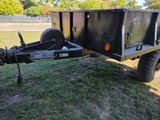 a trailer with a trailer attached to it in the grass