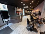 a salon with a counter and chairs in the room