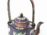 a tea pot with a handle and a handle on it