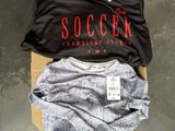 three shirts that are sitting on a cardboard box