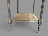 a metal table with a wicker seat on top of it