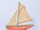 a small model of a sailboat on a stand