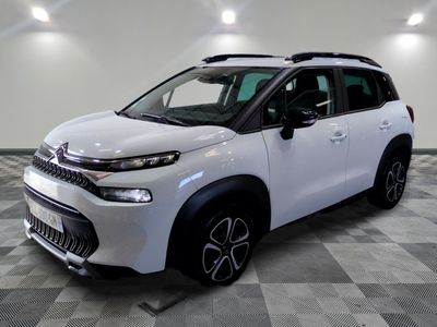the white citrole is parked on a checkered tile floor