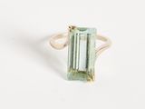 an image of a green tourmaline ring on a white surface