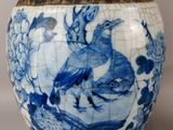 a blue and white vase with a bird on it