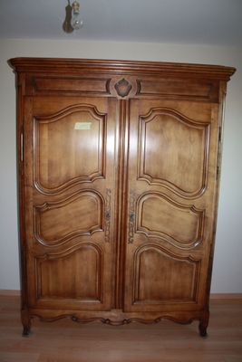 an image of a large wooden armoire in a room