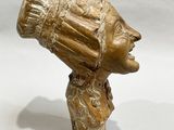 sculpture of a woman ' s head with a hat on it