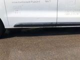 a white van parked in a parking lot near a building
