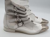 pair of white leather boots with buckles on a white surface