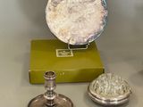 three silver objects sitting on a table next to a green box