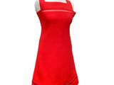 a red dress on a mannequin stand on a white background
