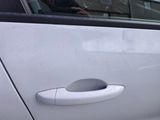 a close up of a car door handle with a person in the background