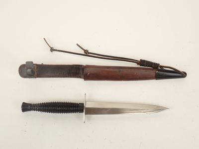 two different types of knives on a white surface