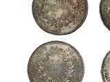 four different types of silver coins on a white background
