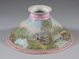 a vase with a painting on it sitting on a table