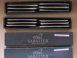 four different types of sabers in a box on a table