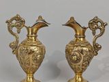 pair of antique brass vases with birds on them on a white background