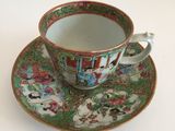 a cup and saucer on a saucer on a white table